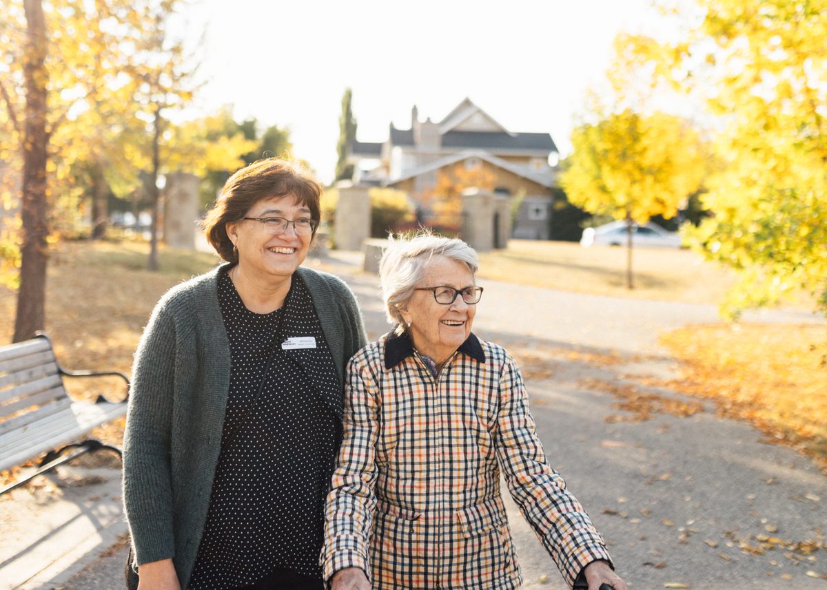 Beyond Neighbours care team walking with a patient outdoors in Calgary